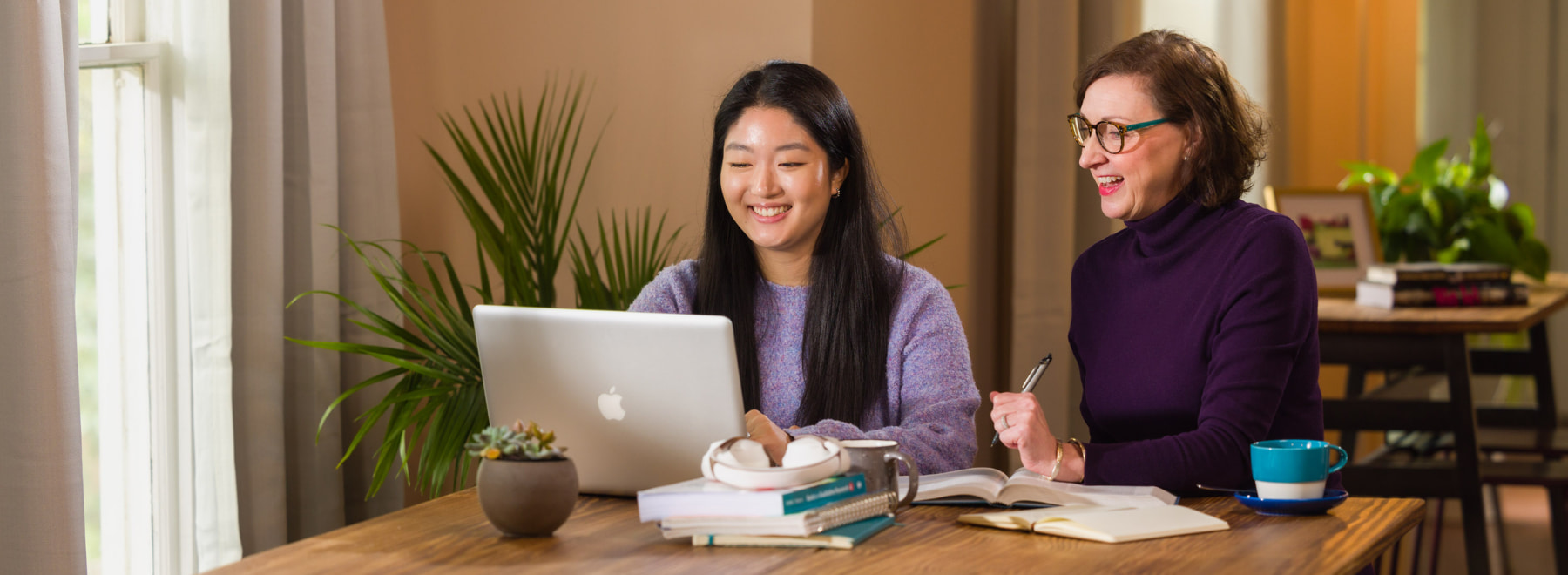 Online learning students in coffee shop attend class on a laptop